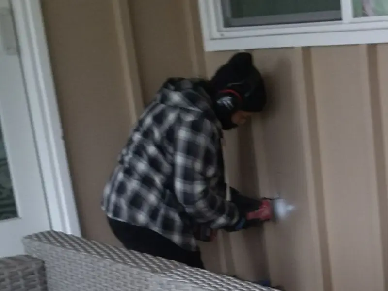 Professional electrician installing an exterior outlet in Thatcher