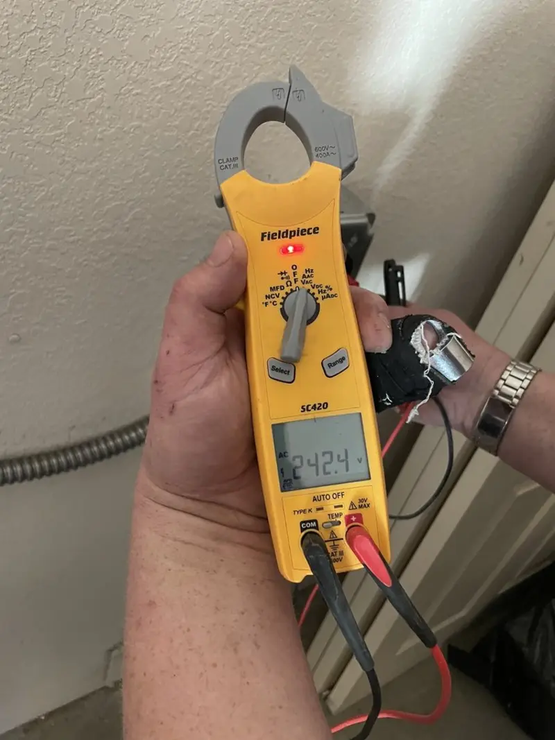 Voltage testing with clamp meter during Recessed Lighting Installation in Thatcher